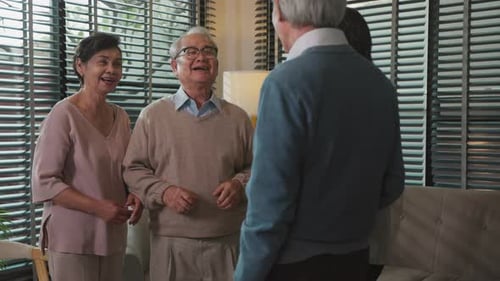 Seniors Enjoying Chat and Laughing Indoors Together