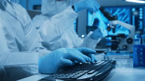 Scientists Work in Futuristic Lab with Microscope