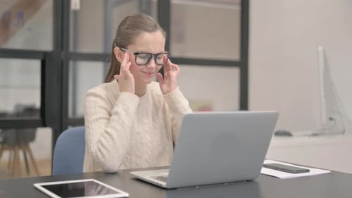 Woman Working at Computer Massaging Temples