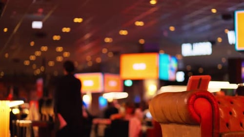 Experience a Vibrant Casino Atmosphere Complete with Colorful Lights and Comfortable Seating Options