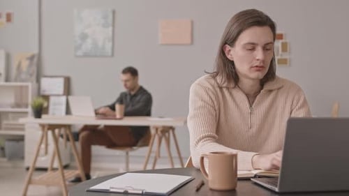 Man Working on Laptop in Office