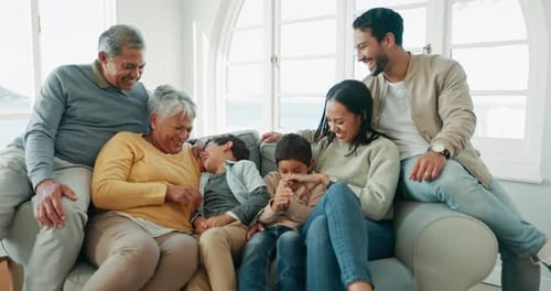 Happy Multi-Generational Family Laughing Together on Couch