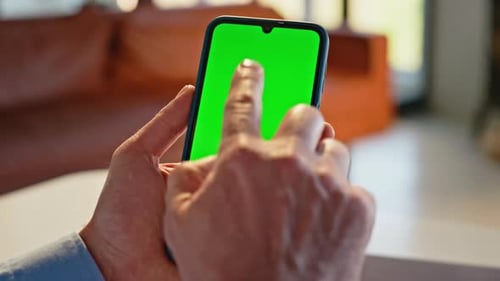 Man Hands Touching Green Screen Smartphone Working Remotely at Home Closeup