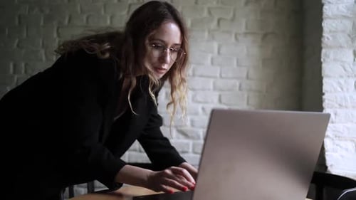 Young Woman Working on Her Laptop Computer in Coffee Shop