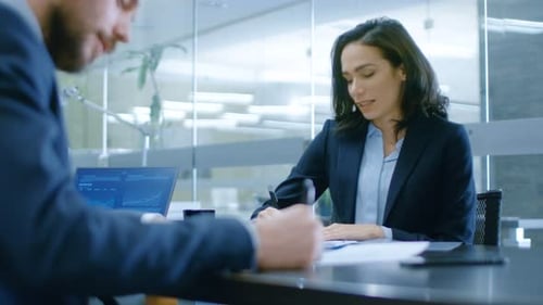 In the Office Close-up on Businesswoman and Businessman Have Conversation, Negotiating, Draw up a C