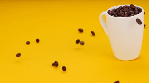 Coffee Beans Spilling From The Cup