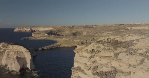 Aerial view of rugged Gozo cliffs overlooking Dwejra Bay, Munxar, Malta.