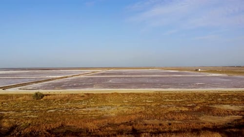 View of a salt flat factory besides the sea - Drone Shot of salt extraction