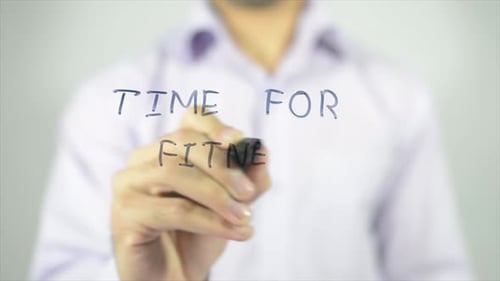 Man Writes Time for Fitness on Glass