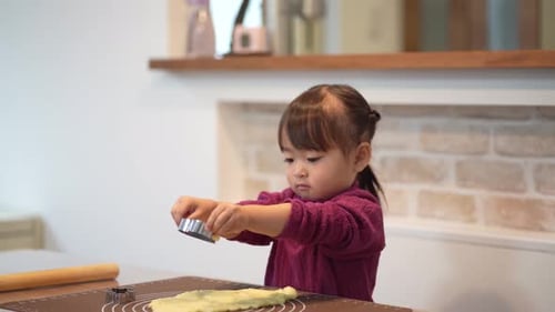 Little Child Baking Cookies in Kitchen