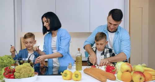 Happy Family Cooking Together in Modern Kitchen