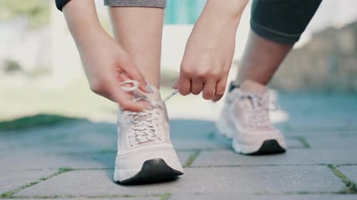 Fitness, sports and hands tie shoes in city for running, marathon training and exercise outdoors