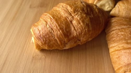 Fresh Golden Croissants on Wood Surface