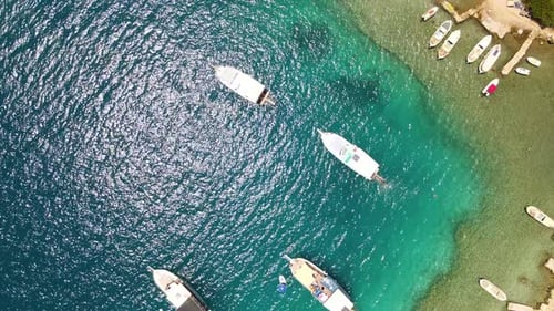Beautiful view of the beach with boats, pure nature, sea and ships. Shot from a drone.