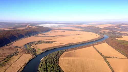 Aerial View of River Flowing Through Rural Landscape