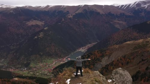 Person Admiring Breathtaking Mountain Landscape in Autumn