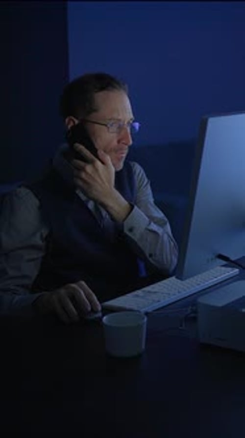 Dedicated and Focused Professional Working Late at Night on a Computer in Office Space
