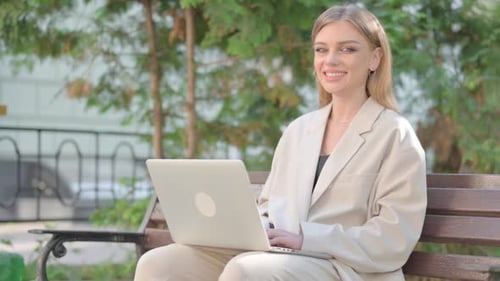Woman Works on Laptop Computer in Park