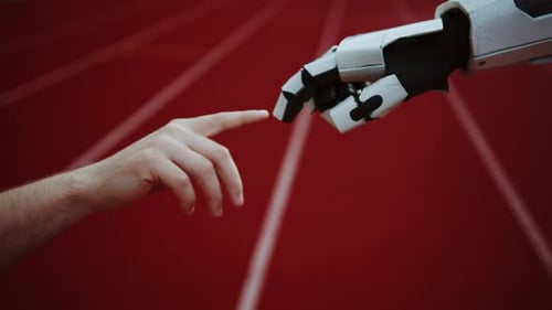 Shooting of Human Hand Touching Hand of Robot on Blurred Background of Modern Sports Court Evolution