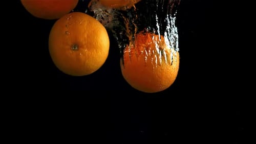 Oranges Fall Under Water Filmed is Slow Motion 1000 Fps