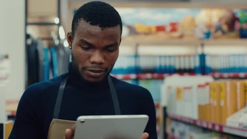 Portrait of African American Man Manager Typing on Smart Tablet in Shop
