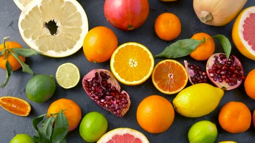 Fresh citrus fruits on a stone table overhead view for healthy eating