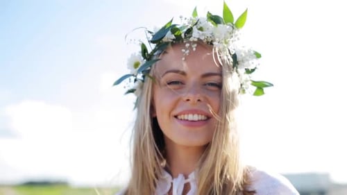Smiling woman with blonde hair wearing a flower crown