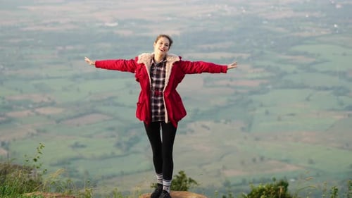 A Woman Walking on a Hill A Woman Standing on a Hill with Her Arms Outstretched Amidst the Untamed