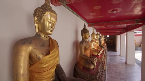 Serene row of golden Buddha statues in Wat Pho Bangkok