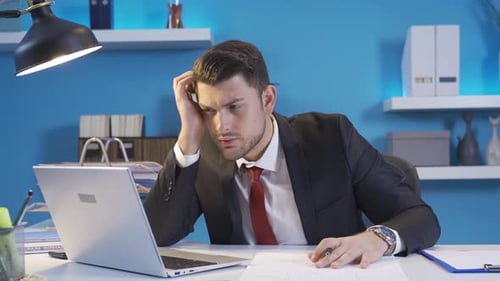 Stressed Young Adult Man Working at Desk