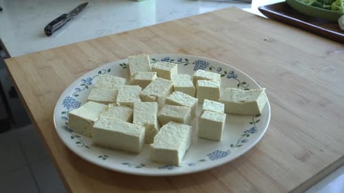 Plate of Tofu Cubes on Butcher Block