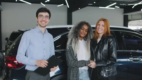 Car Dealership: Salesman with Two Women Buying Car