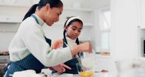 Woman and Child Mixing Ingredients in Kitchen