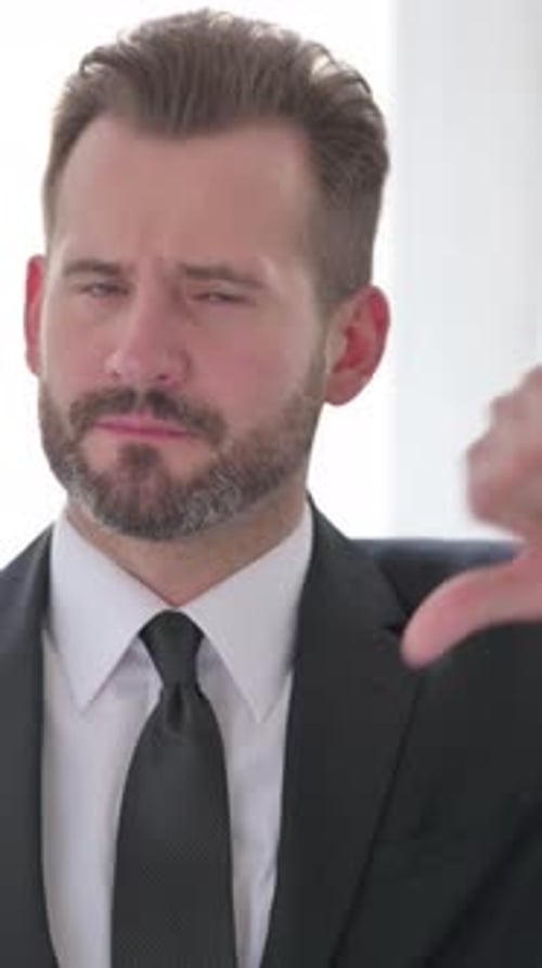 Middle Aged Businessman showing Thumbs Down, Vertical Video