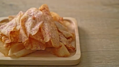 Close Up of Taro Chips on Wooden Tray