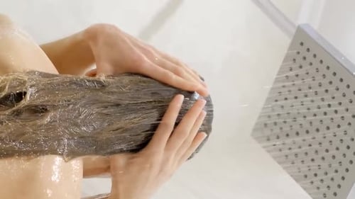 Young Woman Washing Hair in Shower at Home Back View Healthy Lifestyle Vertical Video