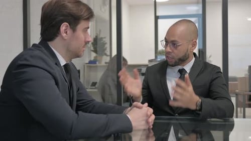 Angry Mixed Race Businessman in Argument with Teammate