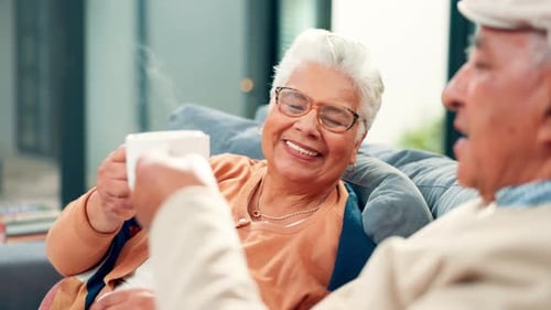 Senior Couple Relaxing Together, Drinking Coffee at Home