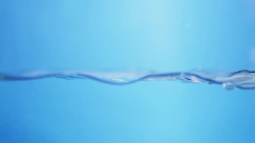 Bubbles rise through clear water in an abstract, underwater view, representing cleanliness, fluidity