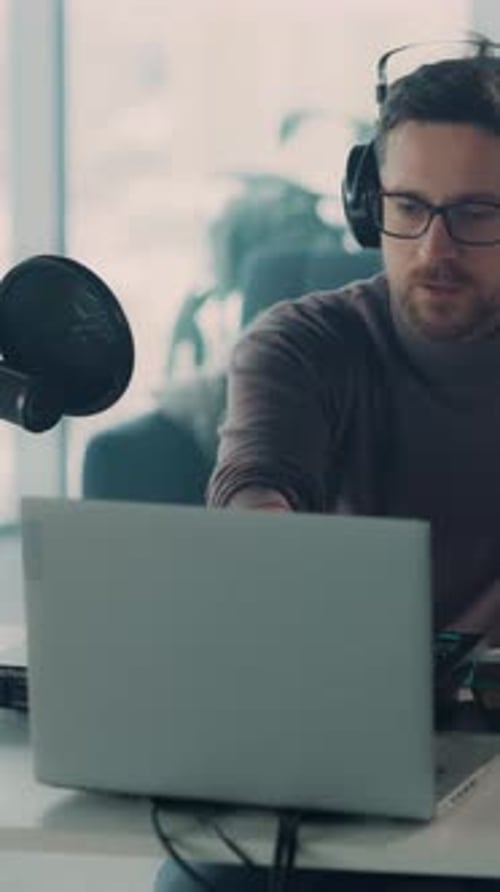 Man Recording Podcast with Audio Equipment at Home