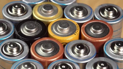 Rows of used alkaline AA batteries. Lithium ion battery pack close up. Electric power supply