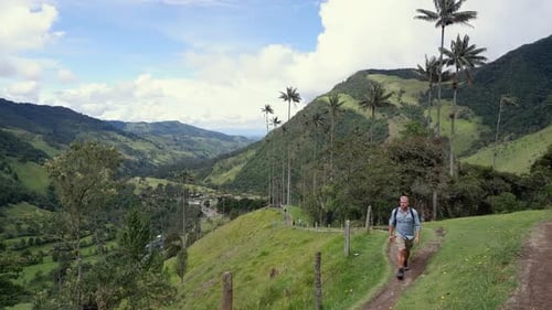 Male hiker walks toward camera in beautiful Cocora Valley of Colombia