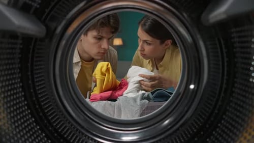 View From Inside the Empty Washing Machine Woman Teaches Her Man How to Use the Washer