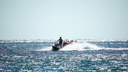 Jet Ski Tows Raft in Ocean