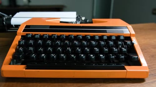 Writing letters with orange retro vintage typewriter