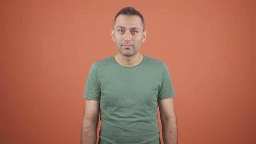 Man Gasps, Hand to Mouth in Surprise