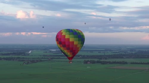 Aerial view of Colorful hot air balloon epic flying above meadow, Netherlands