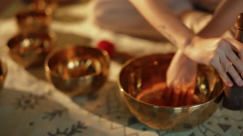 Woman Makes Sound on Tibetan Singing Bowls