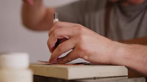 Leathersmith Makes Holes in Workpiece with Fork at Table