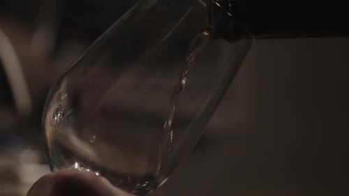 Carefully Pouring White Wine In A Glass - Close Up Shot
